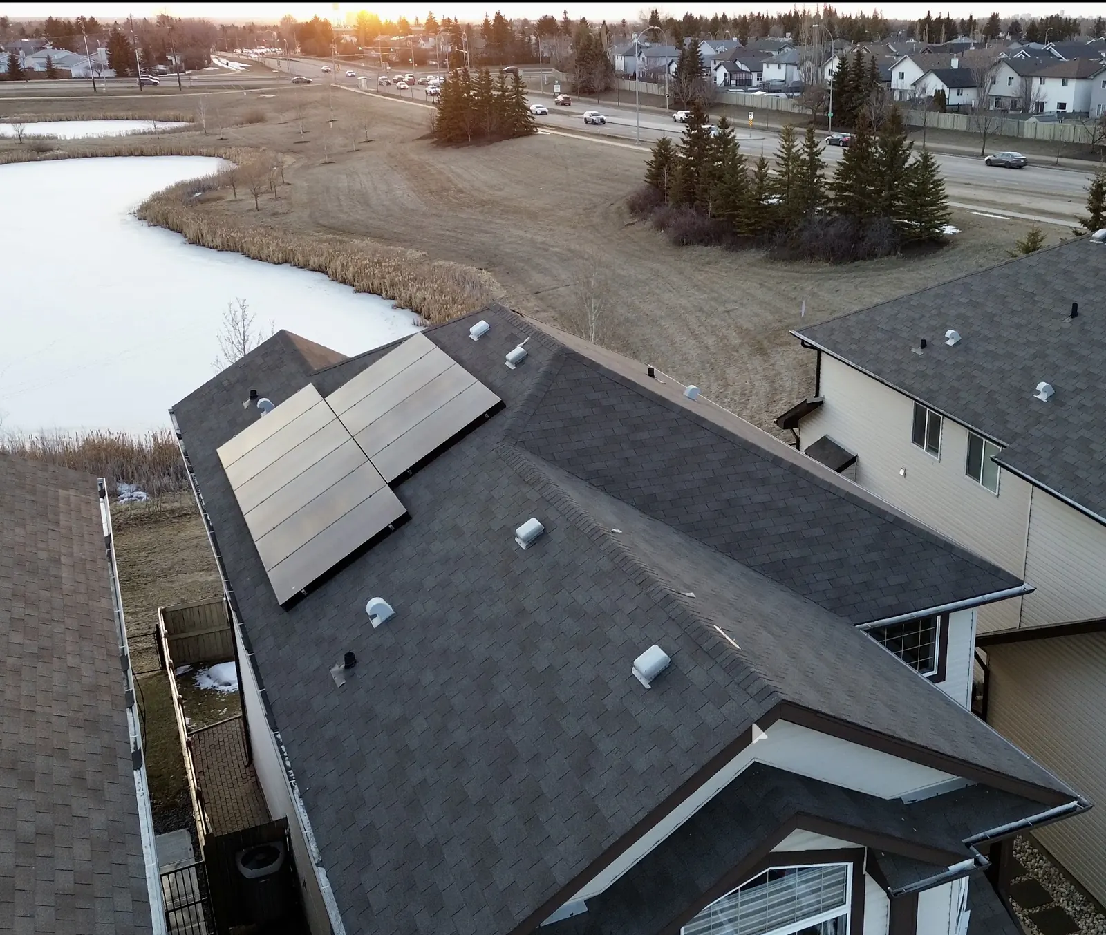 Aerial drone view of a residential solar panel installation in Edmonton, Alberta by Stellar Upgrades