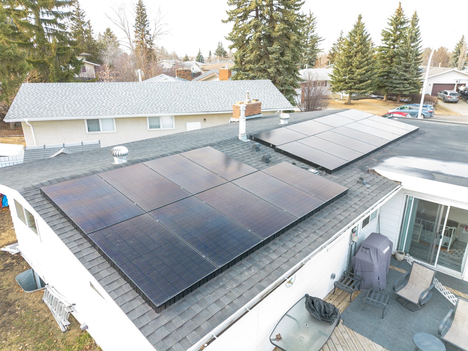 Aerial view of a completed Stellar Upgrades residential rooftop solar installation in an Edmonton neighbourhood