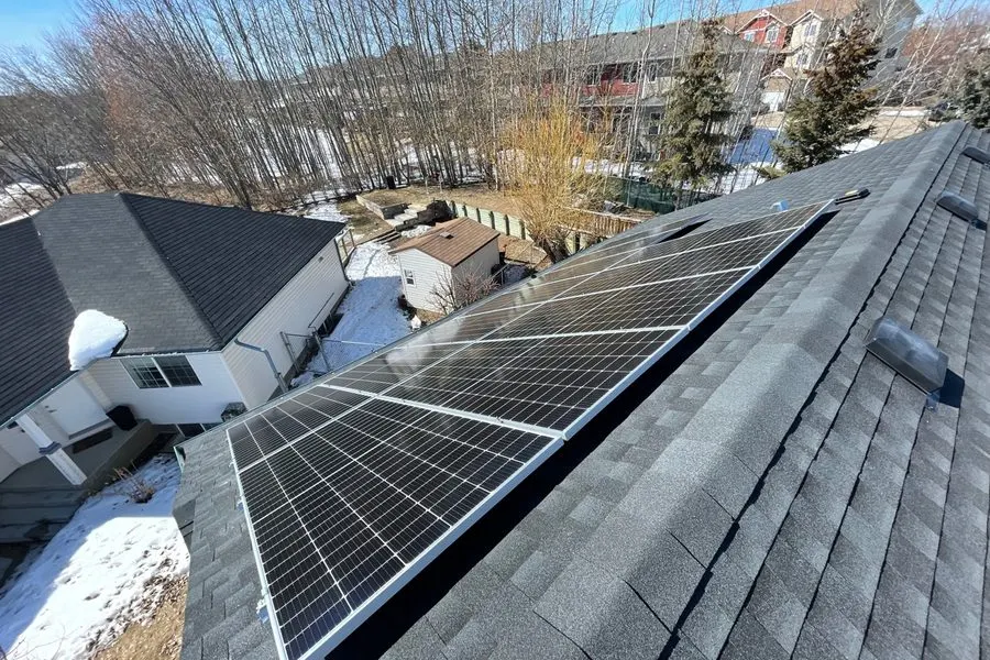 Solar panels producing electricity through Edmonton winter snow