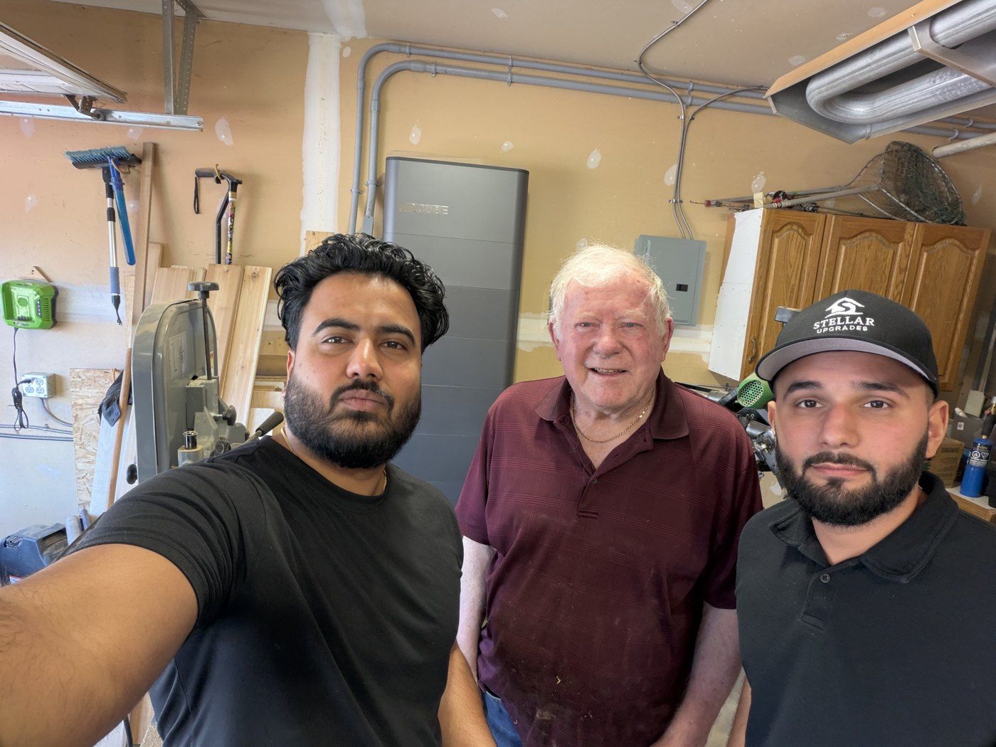 Stellar Upgrades crew with a customer after a battery installation in Sherwood Park, Alberta