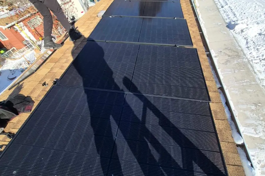 Stellar Upgrades crew installing rooftop solar panels in winter, Alberta
