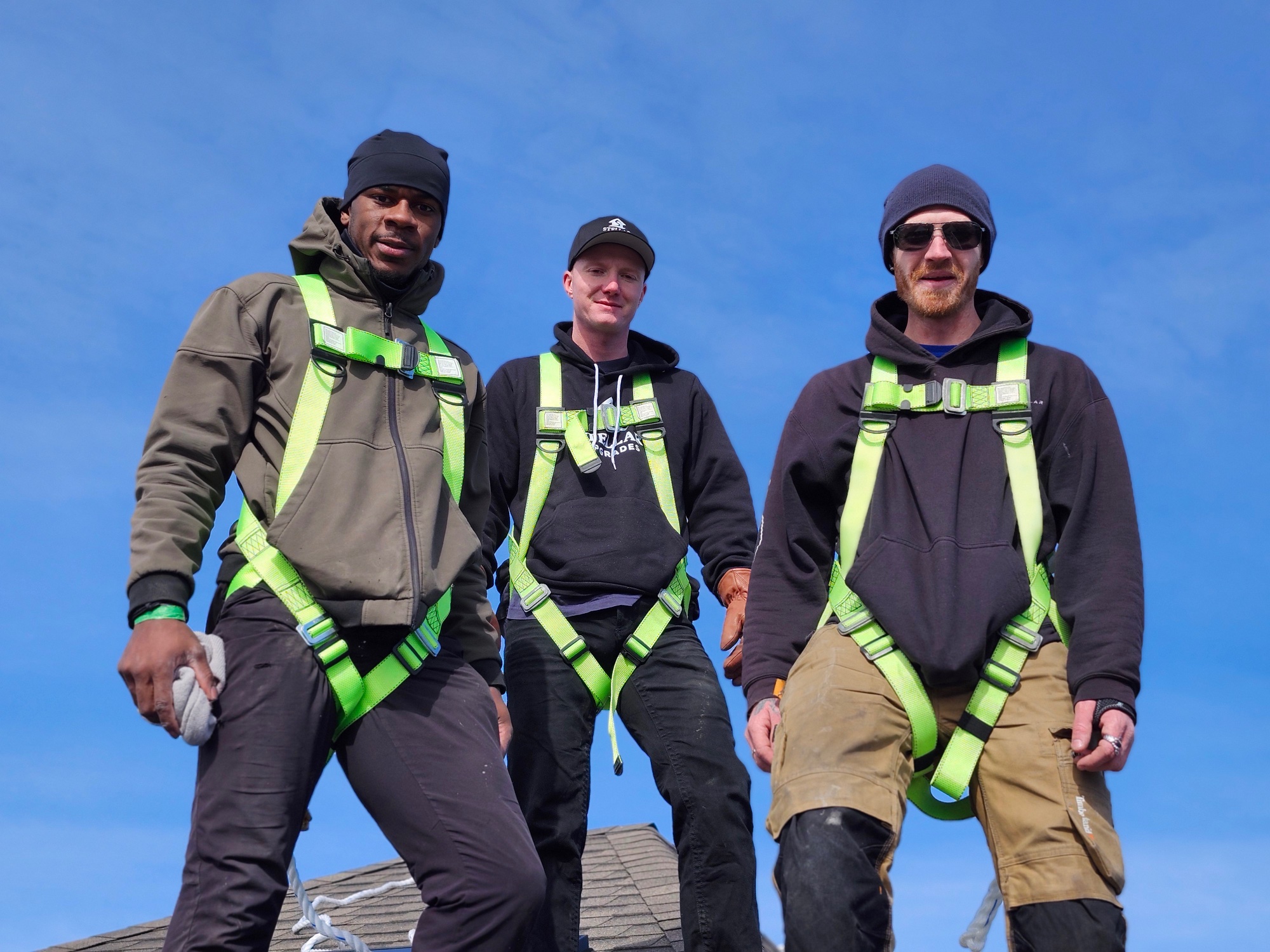 Stellar Upgrades electricians on roof installing solar panels
